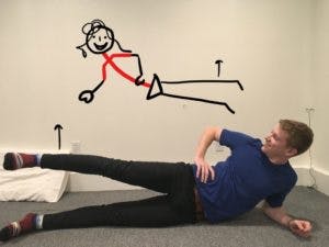 man doing side leg raise exercise