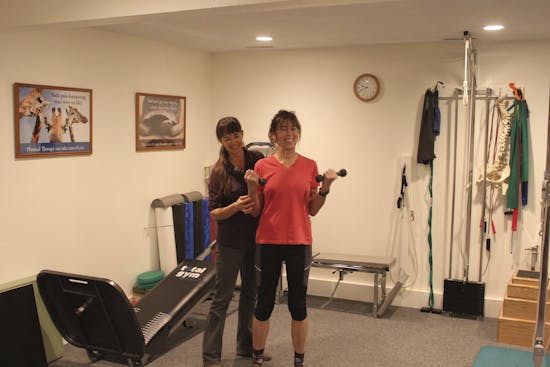 woman exercising with PT supervision