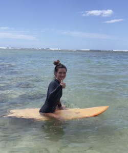 Thumbs up on surfboard