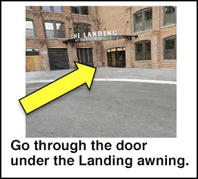 Go through door under the Landing awning