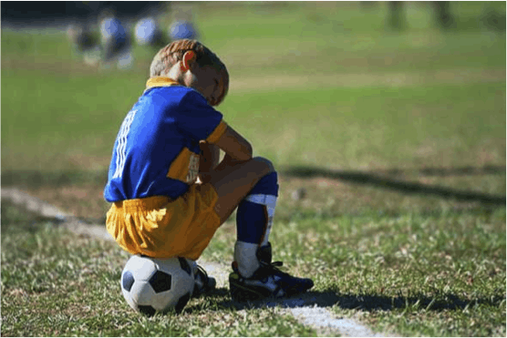 Photo of child on a soccer ball