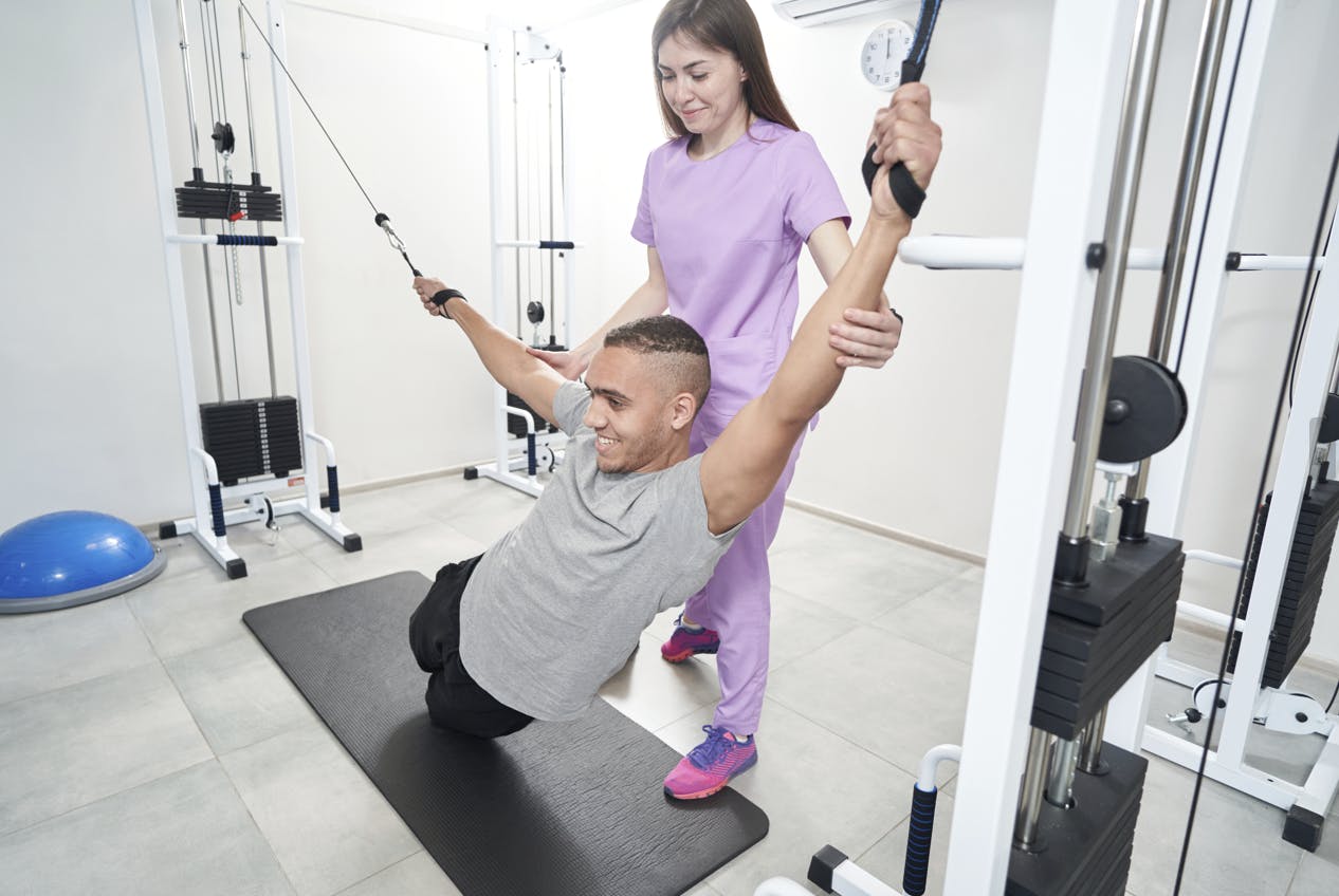 physical therapy with dumbbell support